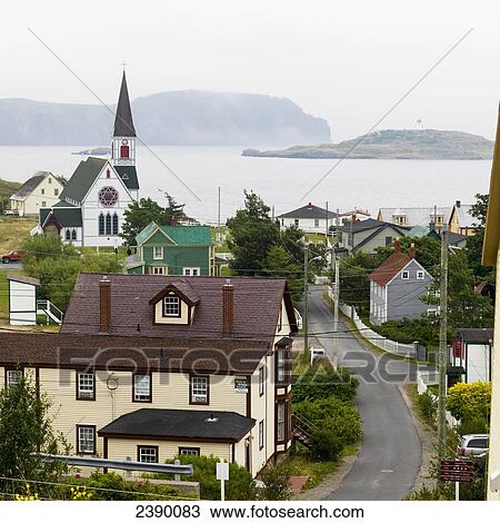 Stock Image - Houses and a church in a quaint atlantic coast town; Trinity, Newfoundland and Labrador, Canada. Fotosearch