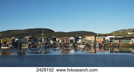 Stock Image - Houses and boats along a shoreline; Trout River, Newfoundland, Canada. Fotosearch