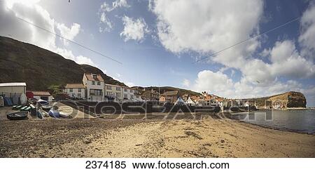 Stock Photography - Houses and cliffs along the coastline; Staithes, Yorkshire, England. Fotosearch