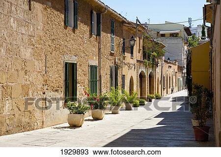 Stock Image - Houses In A Street Of Alcudia, Mallorca, Balearic Islands, Spain. Fotosearch