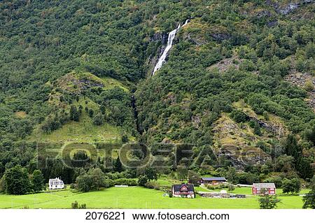 Houses In A Valley With A Waterfall Coming Down The Mountainside; Flam Aurland Norway View Large Photo Image Stock Image - Houses In A Valley With A Waterfall Coming Down The Mountainside; Flam Aurland Norway. Fotosearch