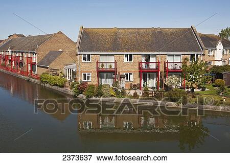 Stock Photo - Houses next to Hilperton Marina on Kennet and Avon Canal; Trowbridge, Wiltshire, England. Fotosearch