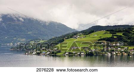 Houses On A Hill Along The Water's Edge Of Hardangerfjord; Hardangervidda Norway View Large Photo Image Stock Photo - Houses On A Hill Along The Water's Edge Of Hardangerfjord; Hardangervidda Norway. Fotosearch