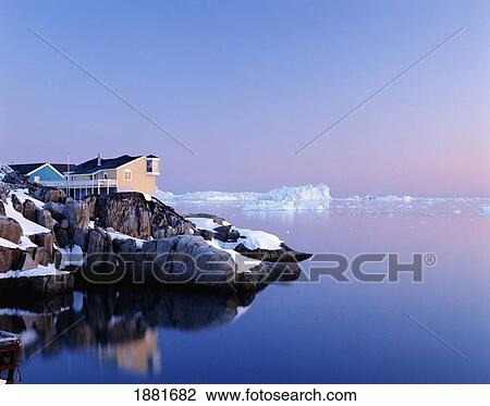 Stock Image - Houses On The Coastline With Icebergs, Disko Bay. Fotosearch