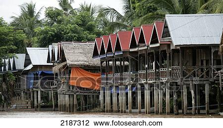 Stock Image - Houses on the Mekong River; Don Det Island, Champasak Province, Laos. Fotosearch