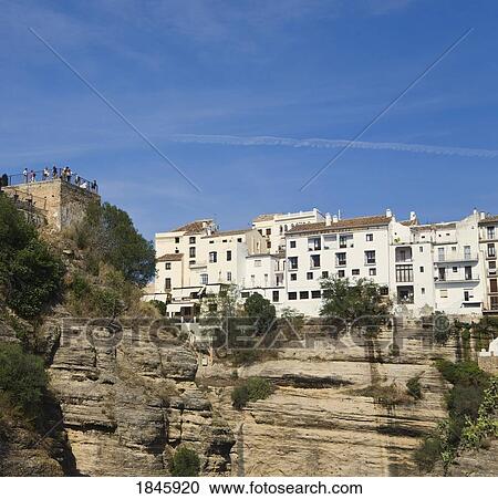 Stock Image - Houses Overlooking Tajo Gorge; Ronda, Malaga Province, Spain. Fotosearch