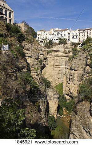 Stock Image - Houses Overlooking Tajo Gorge; Ronda, Malaga Province, Spain. Fotosearch