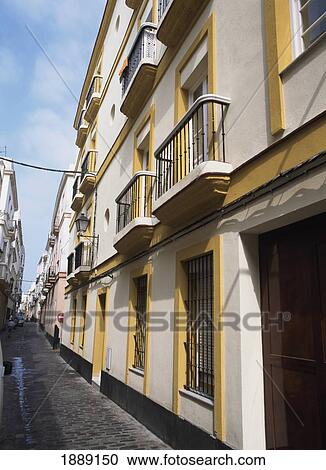 Stock Image - Houses With Balconies In Empty Street. Fotosearch