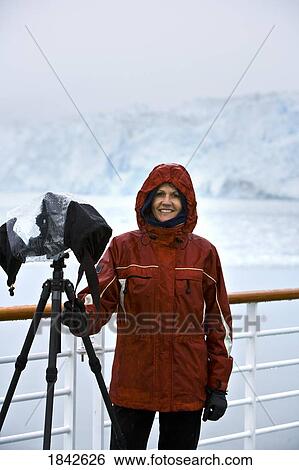 Stock Photograph - Hubbard Glacier, Alaska, Usa; Female Photographer Shooting Glacier From Boat. Fotosearch