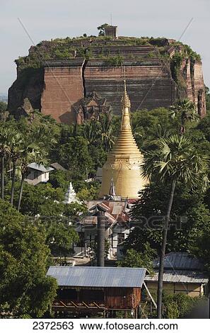 Stock Image - Huge cracks cut through the brick facade of the unfinished Mingun Pagoda that was destroyed by an earthquake; Mandalay, Burma. Fotosearch