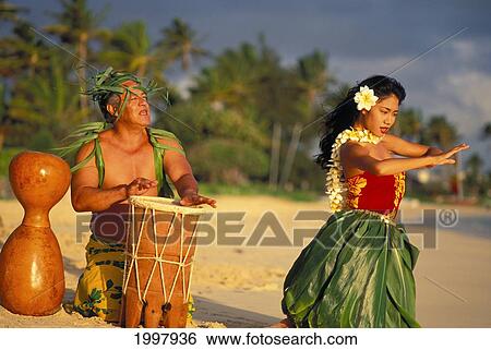 Hula Dancer At Sunrise On Beach With Tahitian Drummer Performing At Water's Edge View Large Photo Image Stock Photograph - Hula Dancer At Sunrise On Beach With Tahitian Drummer Performing At Water's Edge. Fotosearch