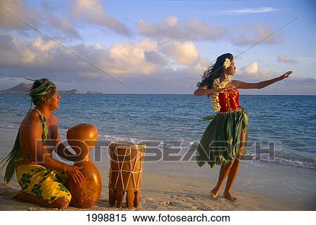 Stock Photography - Hula Dancer At Sunrise On Beach With Tahitian Drummer B1369. Fotosearch
