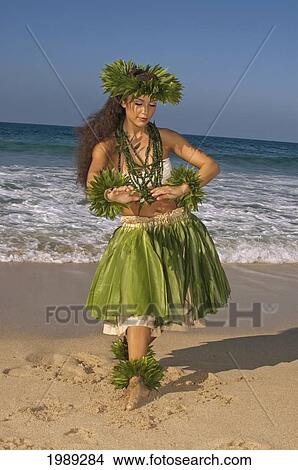 Picture - Hula Dancer In Ti-Leaf Skirt, Haku, Lei, In A Dancing Pose On The Beach. Fotosearch