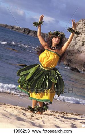 Hula Dancer On Beach With Ocean Background With Ti Leaf Skirt And Yellow Outfit View Large Photo Image Stock Image - Hula Dancer On Beach With Ocean Background With Ti Leaf Skirt And Yellow Outfit. Fotosearch