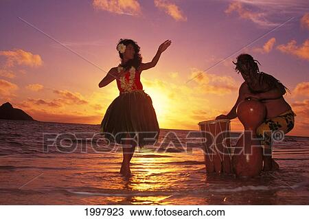 Hula Dancer Performing With Drummer On Beach At Sunrise In Background Hawaii View Large Photo Image Stock Image - Hula Dancer Performing With Drummer On Beach At Sunrise In Background Hawaii. Fotosearch