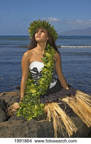 Hula Dancer With Haku Lei In Traditional Outfit On Rocky Coast, Ocean Background View Large Photo Image Picture - Hula Dancer With Haku Lei In Traditional Outfit On Rocky Coast, Ocean Background. Fotosearch