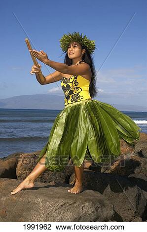 Hula Dancer With Haku Lei In Traditional Outfit On Rocky Coast Holding Kala'au (Sticks), Ocean Background View Large Photo Image Stock Image - Hula Dancer With Haku Lei In Traditional Outfit On Rocky Coast Holding Kala'au (Sticks), Ocean Background. Fotosearch
