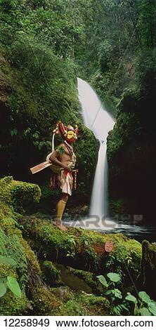 Stock Photo - Huli wigman at waterfall near Ambua Lodge, Southern Highland Province; Hela Province, Papua New Guinea. Fotosearch