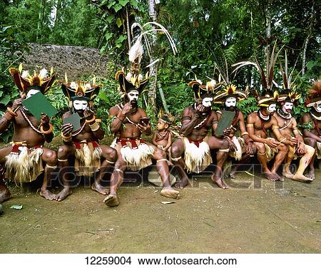 Picture - Huli wigmen prepare for traditional sing-sing; West New Britain, Papua New Guinea. Fotosearch