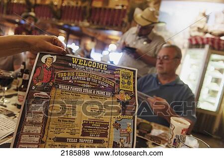 Human Hand Holding Poster Inside The Big Texan Steak Ranch Restaurant, Amarillo, Texas, Usa View Large Photo Image Stock Photo - Human Hand Holding Poster Inside The Big Texan Steak Ranch Restaurant, Amarillo, Texas, Usa. Fotosearch