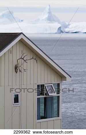 Stock Image - Hunting Is Very Much A Part Of Life In Greenland And Skins And Antlers Can Be Seen All Around Town. House With Icefjord Behind. Ilulissat, Greenland.. Fotosearch