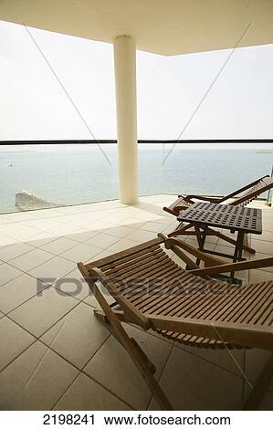 Stock Image - Ibiza, Chairs and Balcony at Coastline apartments; San Antonio. Fotosearch
