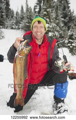 Ice fisherman holding a large brook trout; Ontario, Canada View Large Photo Image Stock Image - Ice fisherman holding a large brook trout; Ontario, Canada. Fotosearch