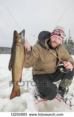 Ice fisherman holding a large brook trout; Ontario, Canada View Large Photo Image Stock Image - Ice fisherman holding a large brook trout; Ontario, Canada. Fotosearch
