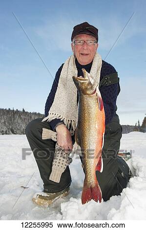 Ice fisherman holding a large splake fish; Ontario, Canada View Large Photo Image Stock Photography - Ice fisherman holding a large splake fish; Ontario, Canada. Fotosearch