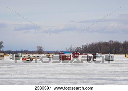 Stock Photo - Ice Fishing Huts On A Frozen River; Valleyfield, Quebec, Canada. Fotosearch