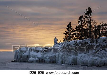 Stock Photography - Ice on Lake Superior at sunrise; Grand Portage, Minnesota, United States of America. Fotosearch