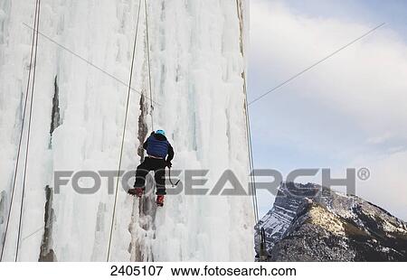 Stock Photo - Ice wall climbing demonstration; Banff, Alberta, Canada. Fotosearch