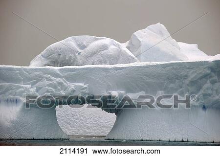 Stock Image - Iceberg With A Hole Through It; Antarctica. Fotosearch