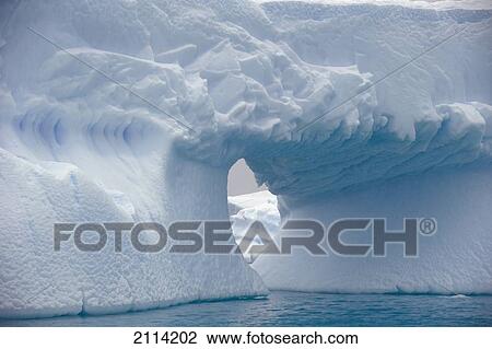 Stock Image - Iceberg With A Hole Through It; Antarctica. Fotosearch