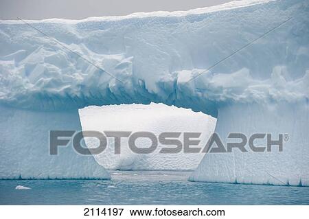 Stock Photo - Iceberg With A Hole Through It; Antarctica. Fotosearch