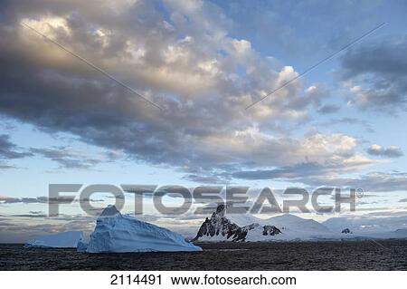 Stock Image - Icebergs And The Coastline; Antarctica. Fotosearch
