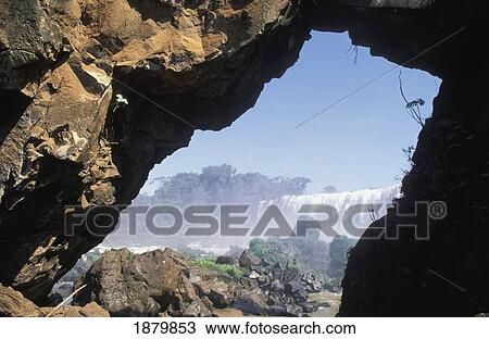 Stock Image - Iguassu Falls Seen Through Natural Arch. Fotosearch