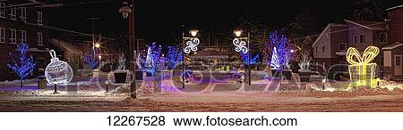 Stock Photo - Illuminated Christmas decorations illuminate a community at nighttime; Waterloo, Quebec, Canada. Fotosearch