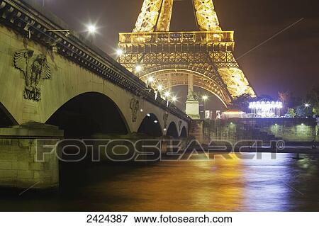 Illumination of the Eiffel Tower and lights reflected in the Seine River; Paris, France View Large Photo Image Stock Photo - Illumination of the Eiffel Tower and lights reflected in the Seine River; Paris, France. Fotosearch