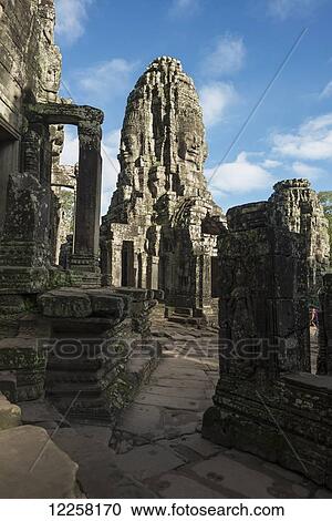 Stock Image - Impressive Buddha's faces in Bayon Wat, built by the king Jayavarman VII in the end of twelfth century, from Angkor; Siem Reap, Cambodia. Fotosearch