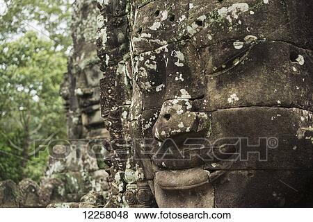 Stock Photo - Impressive Buddha's faces in Bayon Wat, built by the king Jayavarman VII in the end of the 12th Century, from Angkor; Siem Reap, Cambodia. Fotosearch