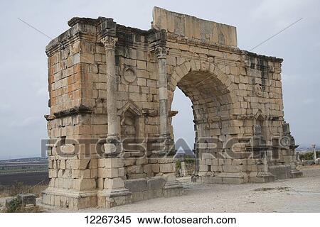 Stock Photography - Impressive Roman arch dominating the landscape; Volubilis, Mauritania, Morocco. Fotosearch