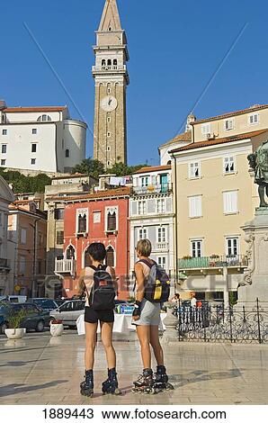Stock Image - In-Line Skating Women Tourists At Tartini Square.. Fotosearch