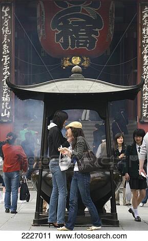 Stock Image - Incense Burning Outside The Senso-Ji Temple, Asakusa, Tokyo, Japan - Copyright Mark Thomas/Axiom. Fotosearch