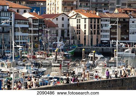 Stock Photograph - Incidental People At Lekeitio Harbor, Basque Country, Spain. Fotosearch