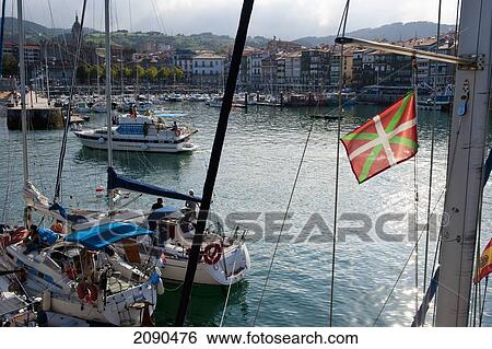 Stock Photograph - Incidental People In Watercraft At Lekeitio Harbor, Basque Country, Spain. Fotosearch