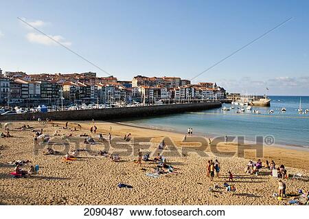 Stock Photo - Incidental People Sunbathing On The Beach At Lekeitio, Basque Country, Spain. Fotosearch