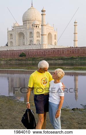 India, Agra, Tourist Couple Standing In Front Of The Taj Mahal. View Large Photo Image Stock Image - India, Agra, Tourist Couple Standing In Front Of The Taj Mahal.. Fotosearch