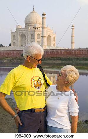 India, Agra, Tourist Couple Standing In Front Of The Taj Mahal. View Large Photo Image Stock Photo - India, Agra, Tourist Couple Standing In Front Of The Taj Mahal.. Fotosearch