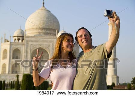 Stock Photo - India, Agra, Tourist Couple Taking Photo Of Themselves In Front Of The Taj Mahal.. Fotosearch